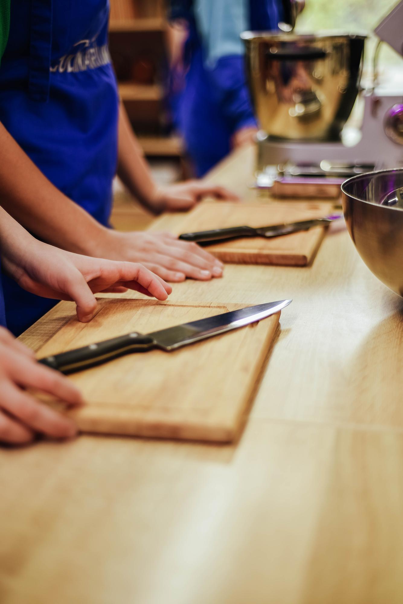 Students around a bench learning knife skills