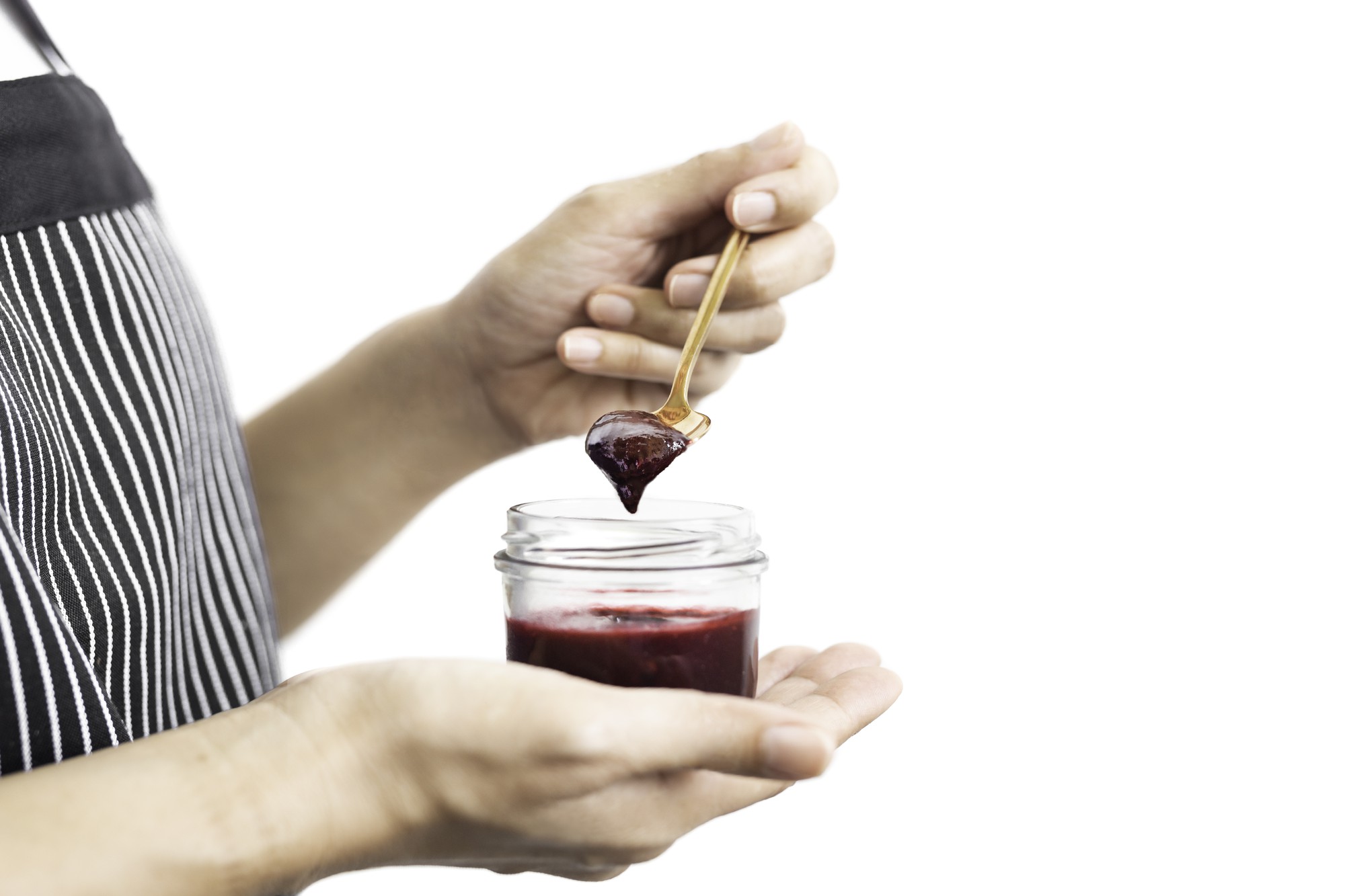 Hands finishing a dessert with sauce